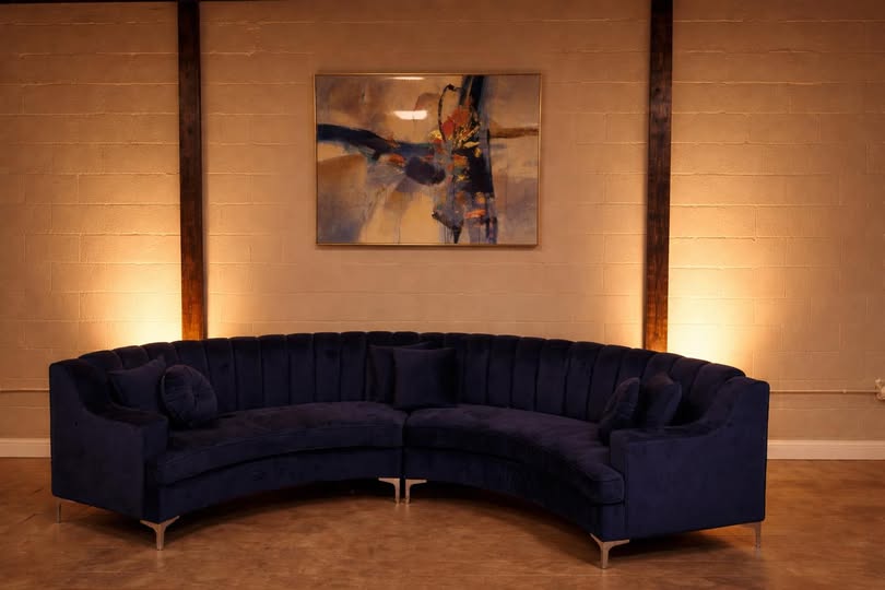 Curved navy sofa in main room
